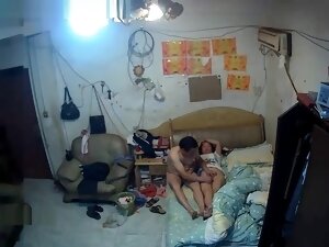 The rented uncle goes to bed with his wife who is playing with her mobile p