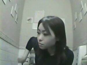 Nice asian woman is caught on camera while pissing in toilet