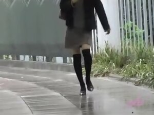 Asian babe gets a nasty skirt sharking on a rainy day.